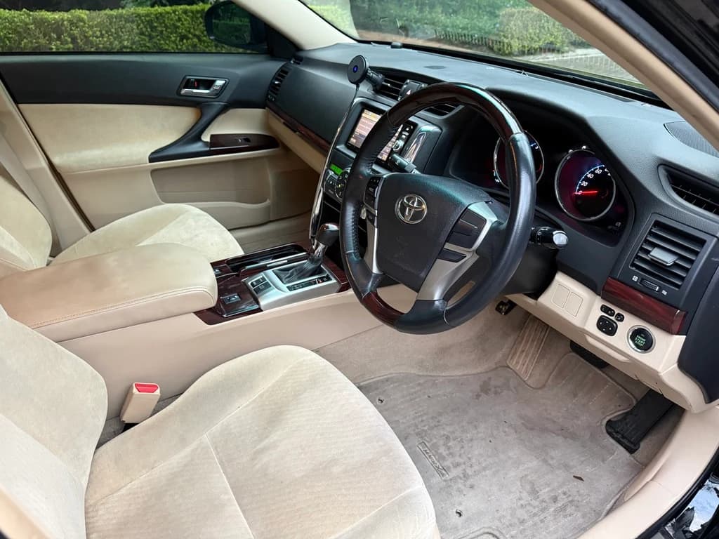 Cream seats and wood trim inside a Toyota Mark X